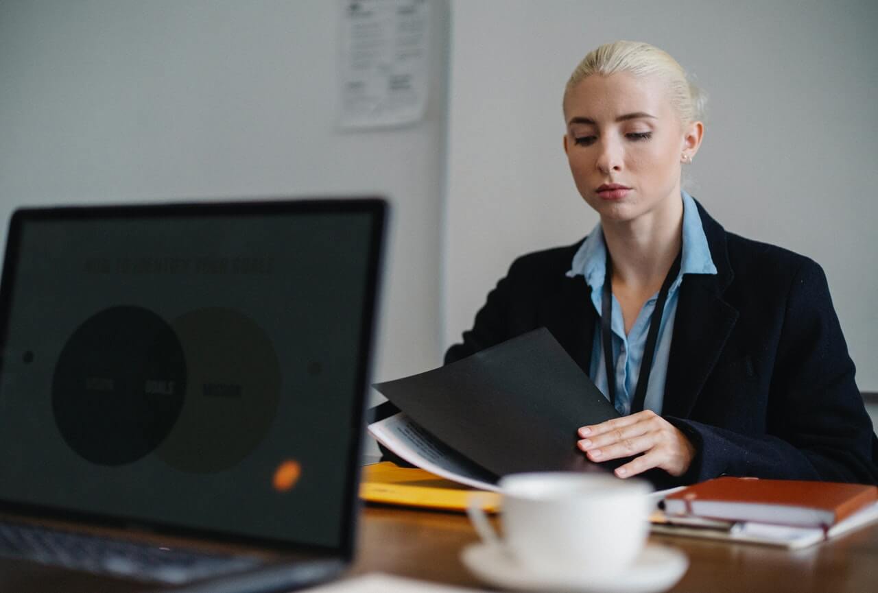 A businesswoman going through a file on her table