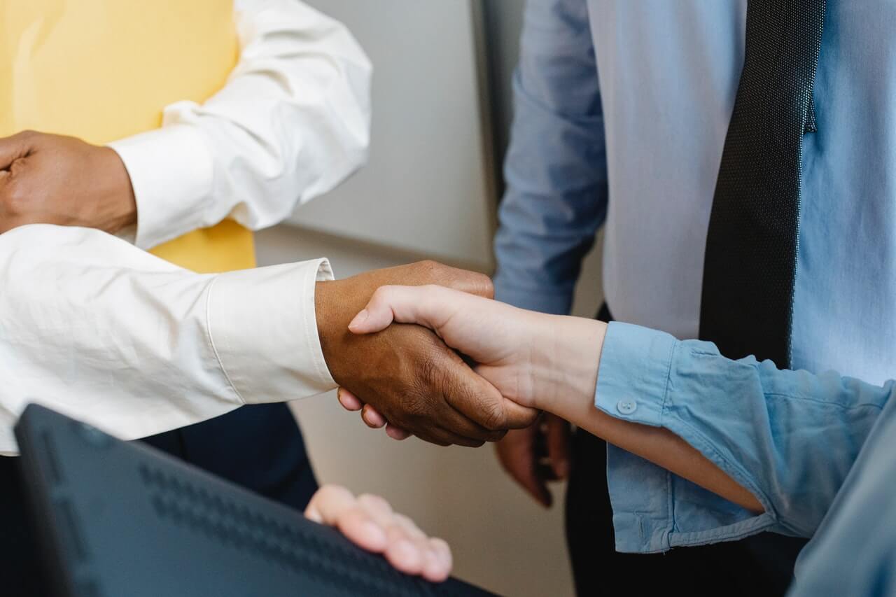 Businessmen in suit shaking hands to close a contract