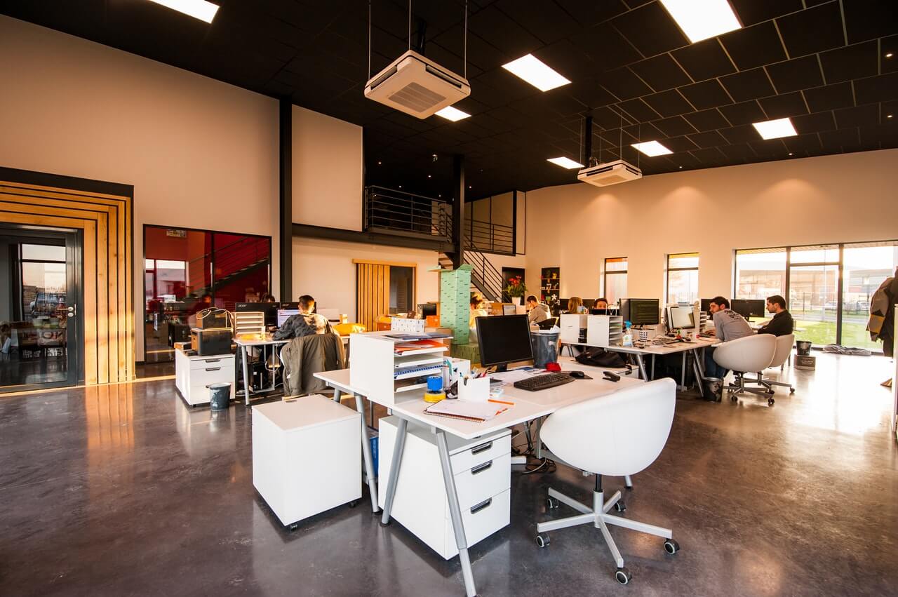 An office floor with people sitting at their desks