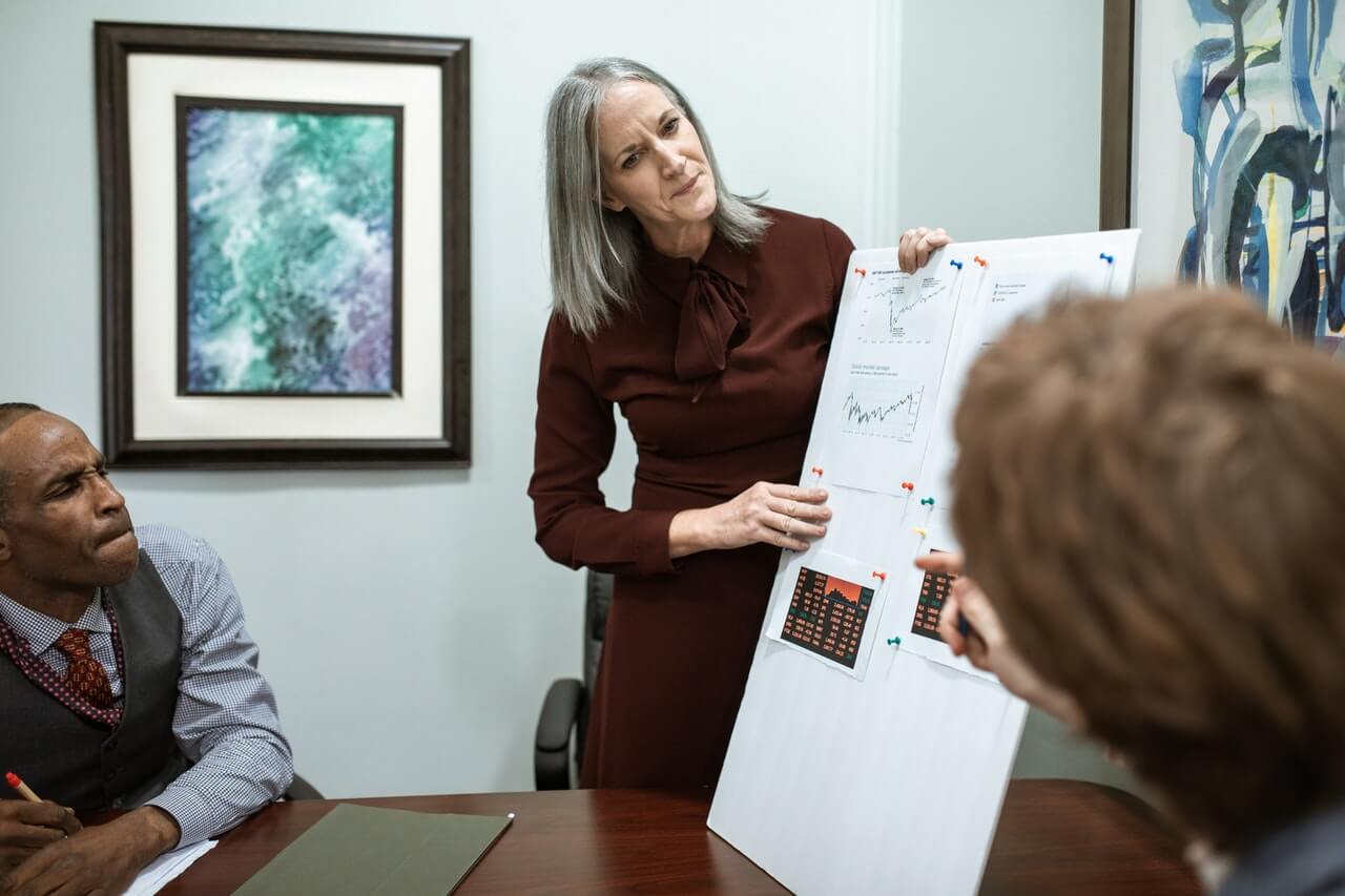 A businessperson presenting in a board meeting