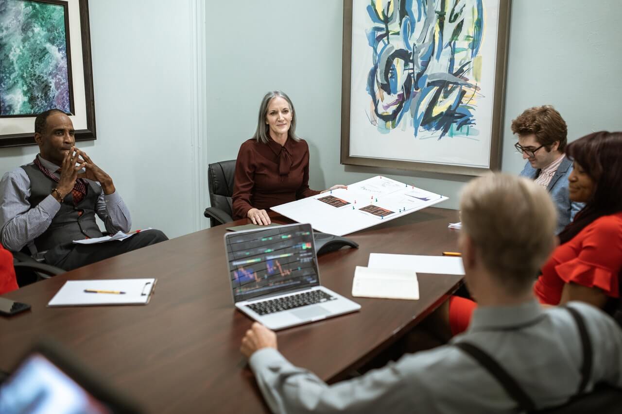 Business women and men in a board conference