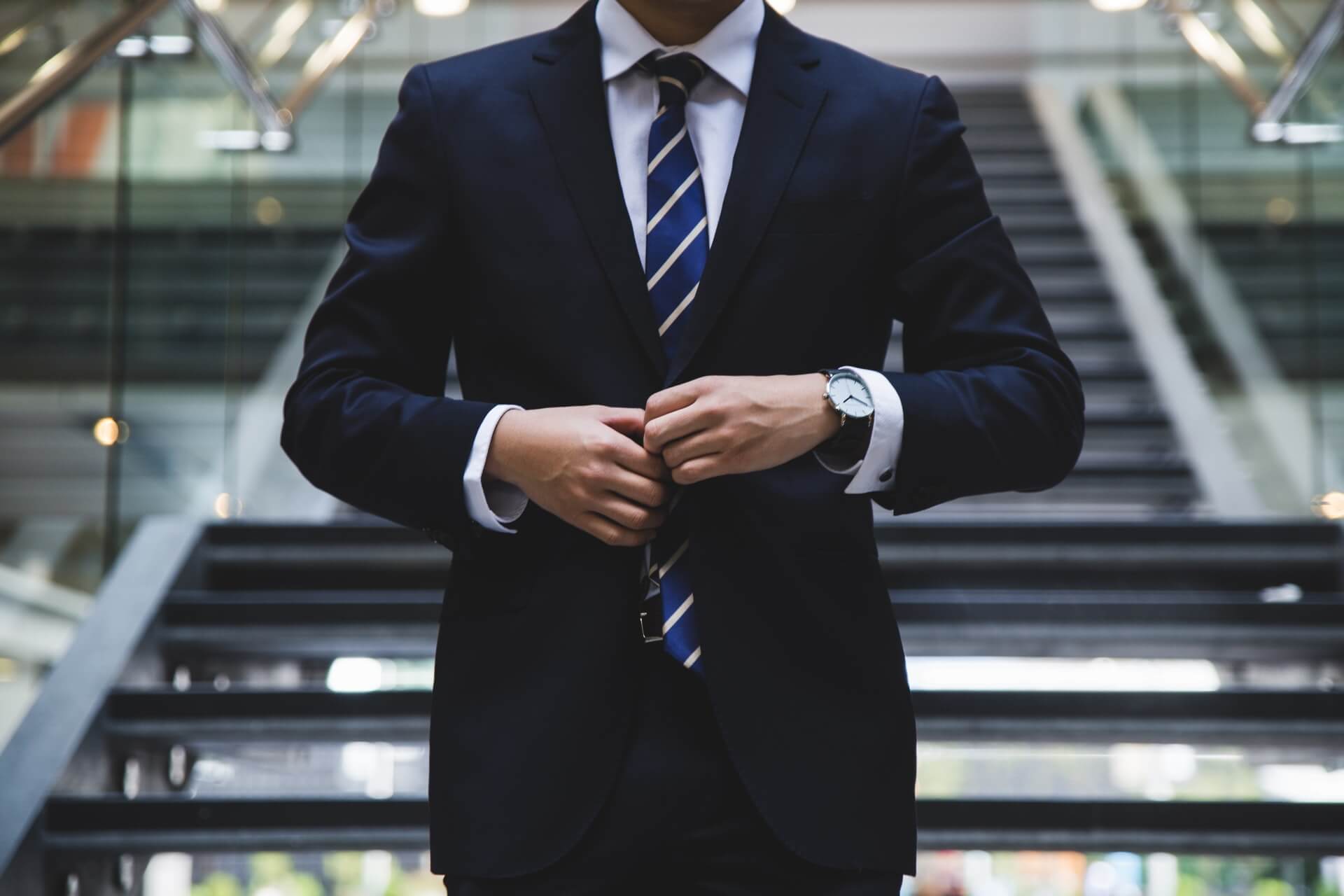 Businessman in suit standing near the stairs