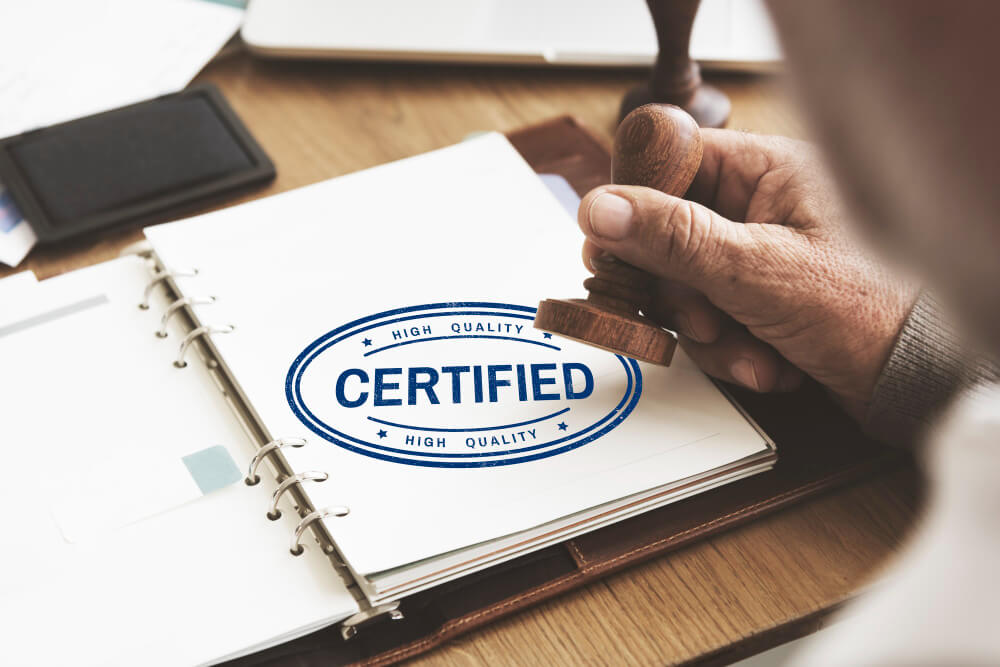 Person using a certified stamp on a book