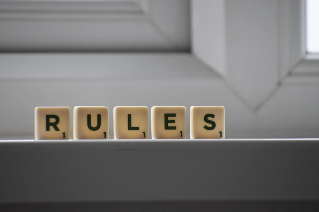 Scrabble tiles spelling the word "rules"