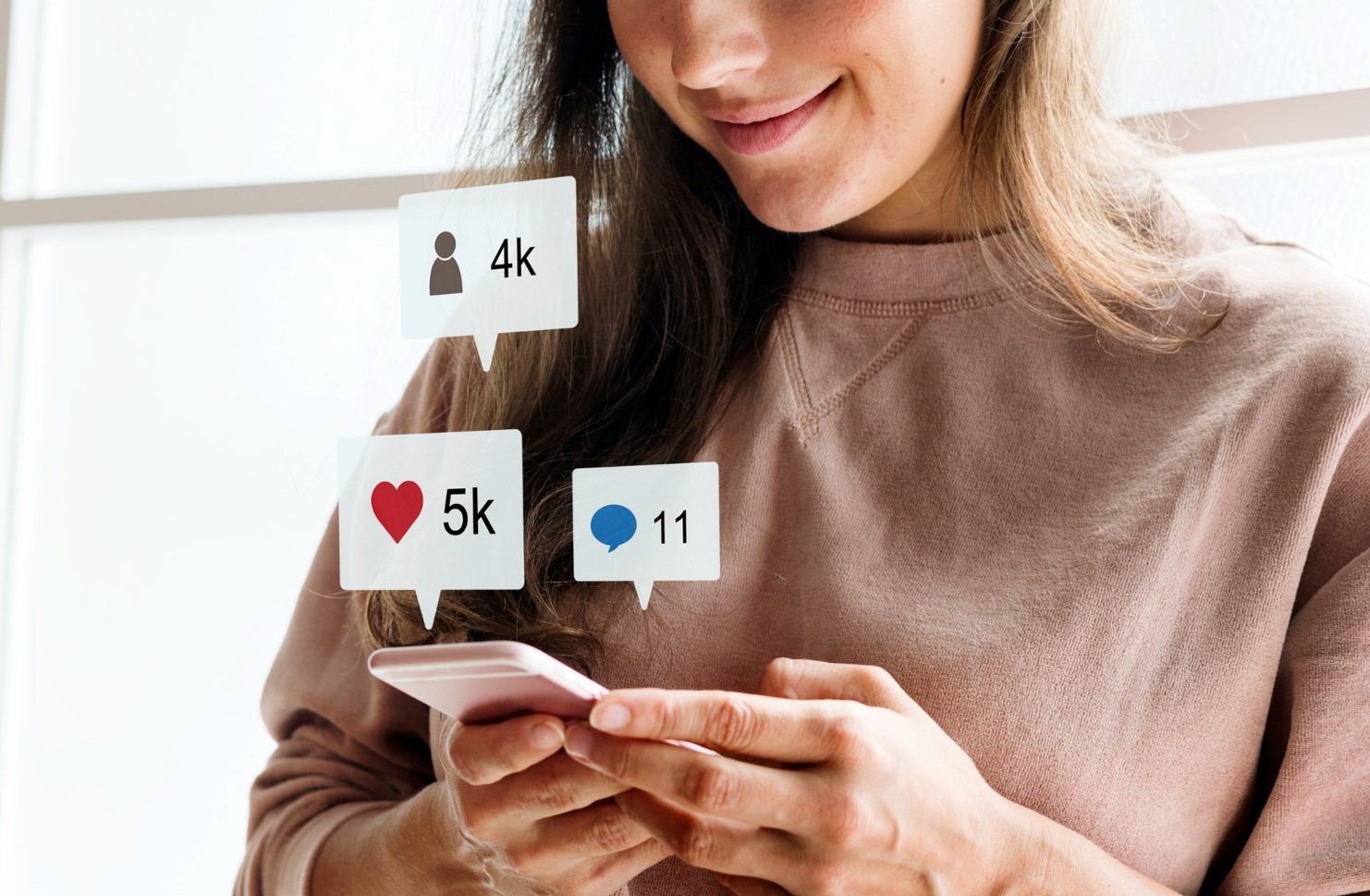 Woman using a smartphone on social media smiling