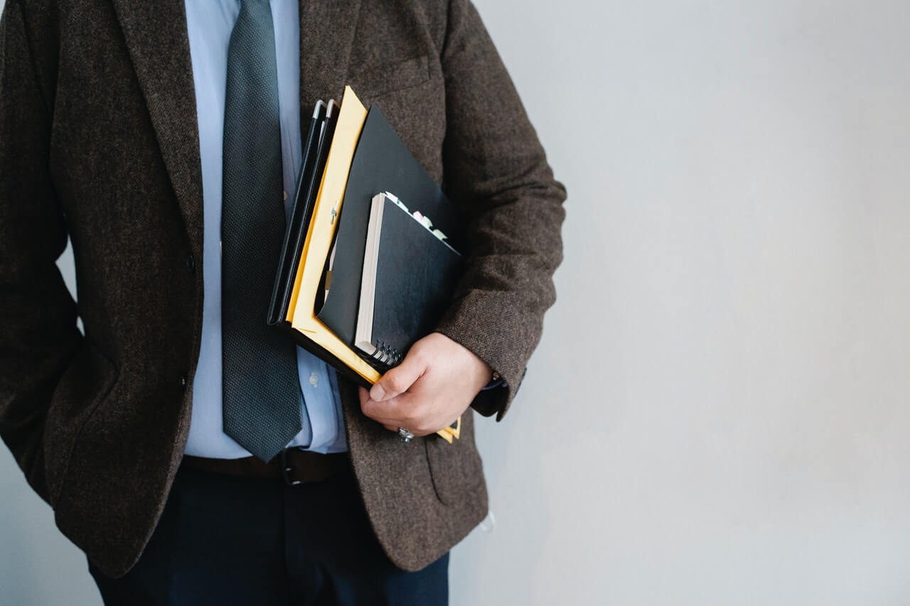 Corporate person holding a couple of documents