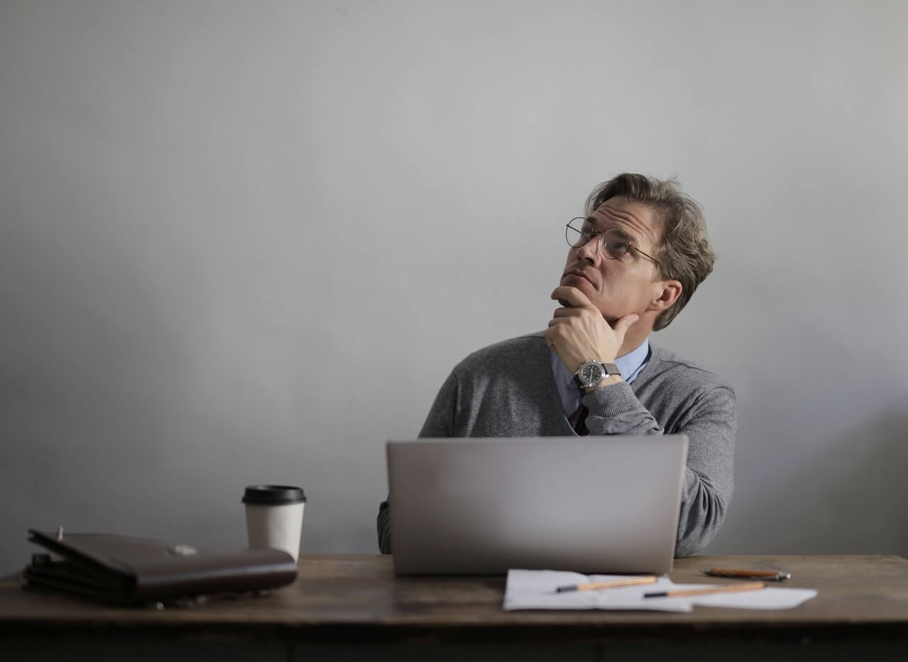 Contemplative male manager at his office desk