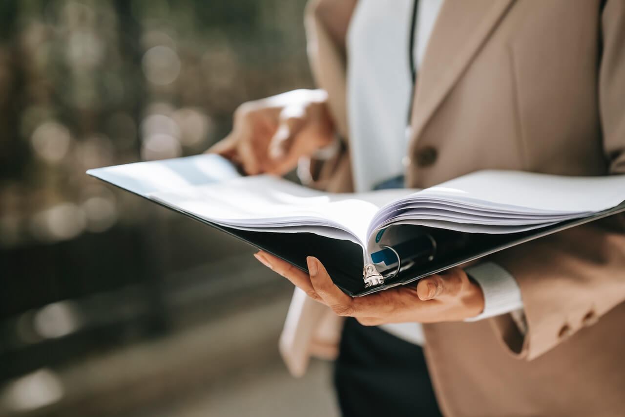 Businesswoman studying documents while standing