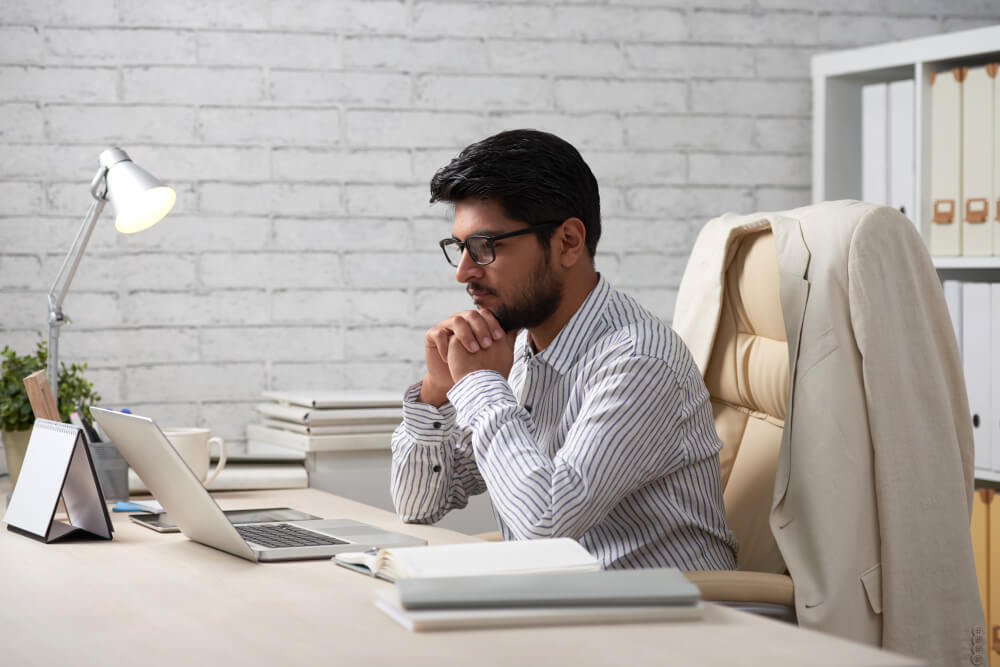 Businessman lost in thoughts after reading a bad news correspondence