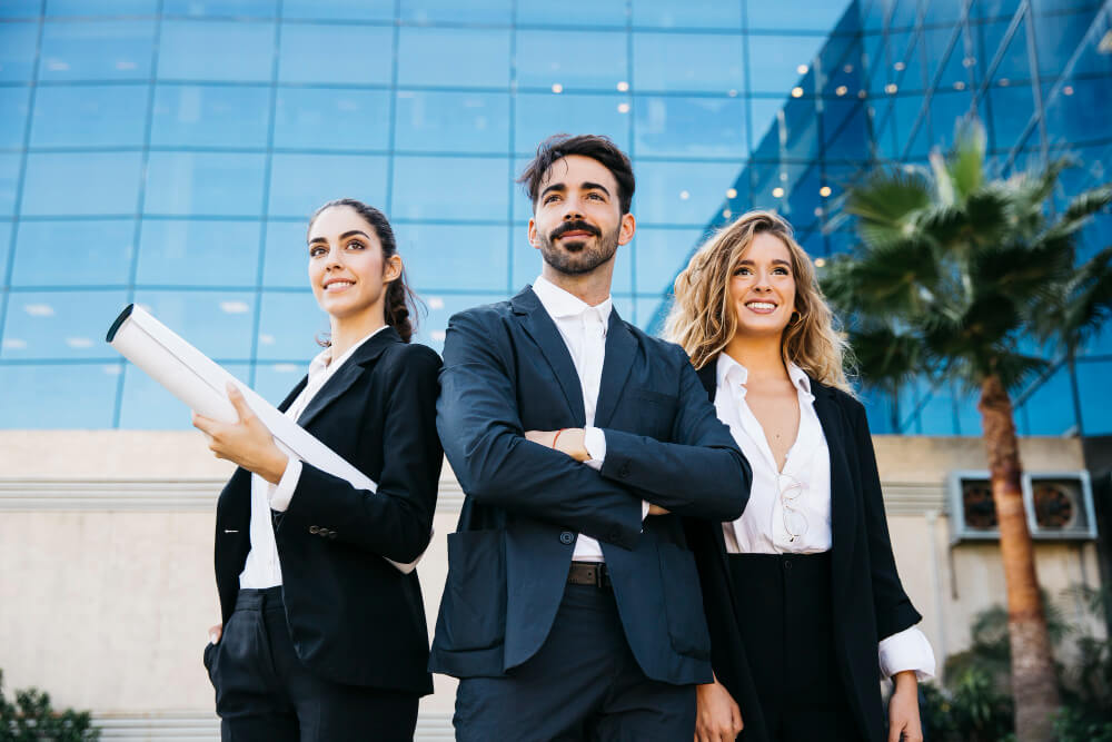 Three businesspeople standing in front of a building