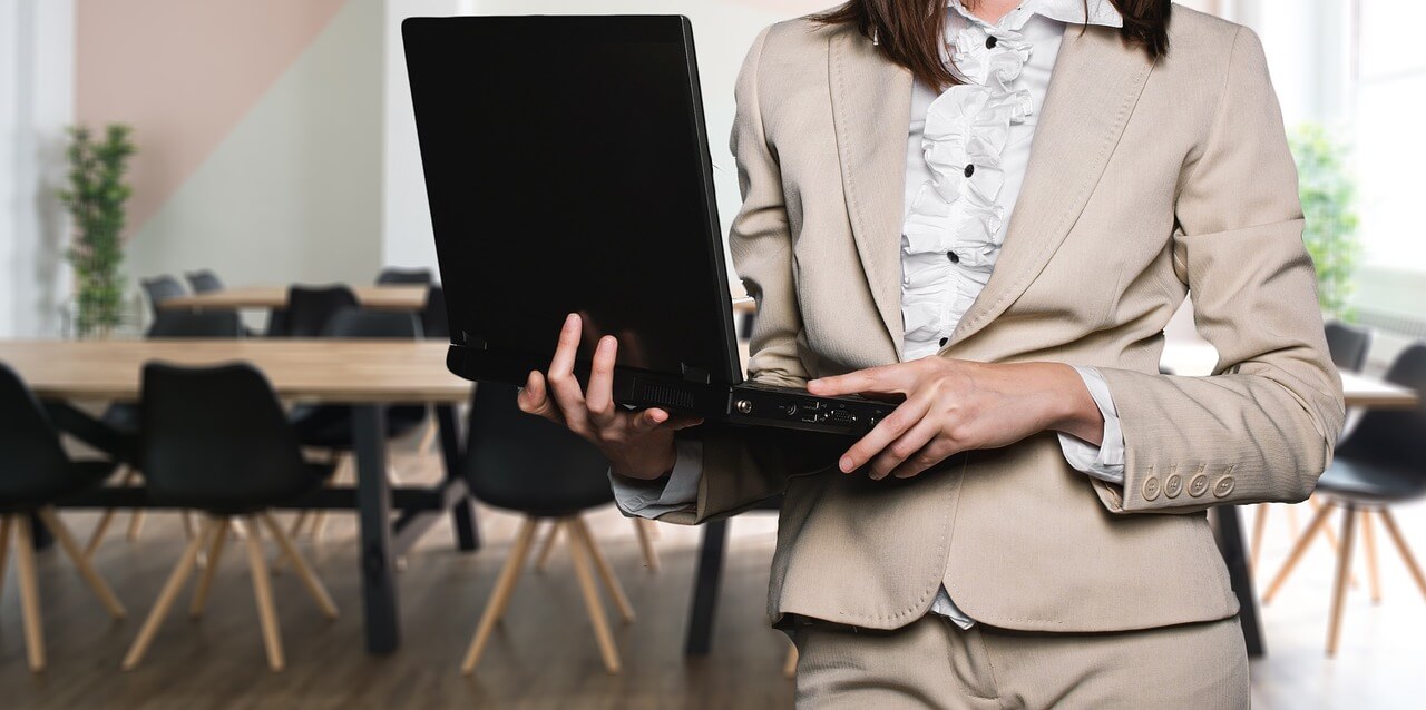 A fundraising/development consultant holding a laptop