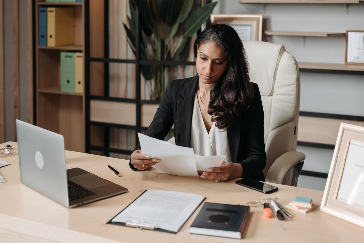 Woman reading a report file at work