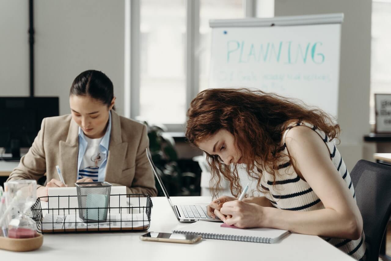 Two businesswomen planning a strategy in an office