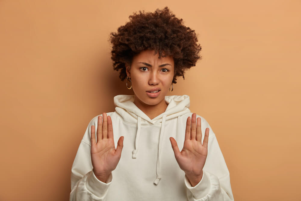 Young woman making a stop sign with her hands