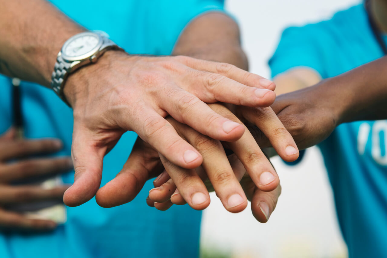 A-team-of-volunteers-making-a-hand-stack