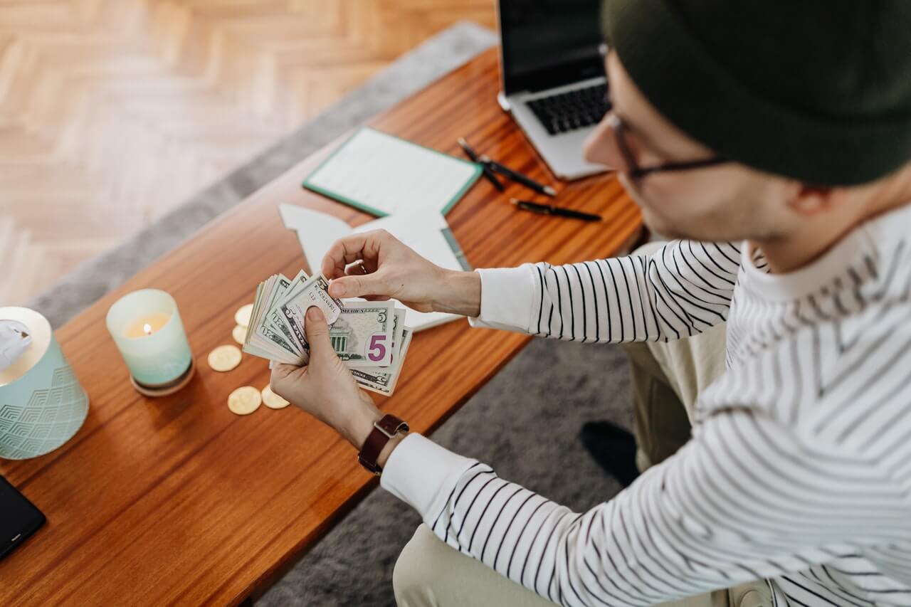 Man counting money from a fundraising event