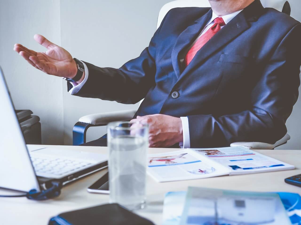 Man in suit sitting at his office desk