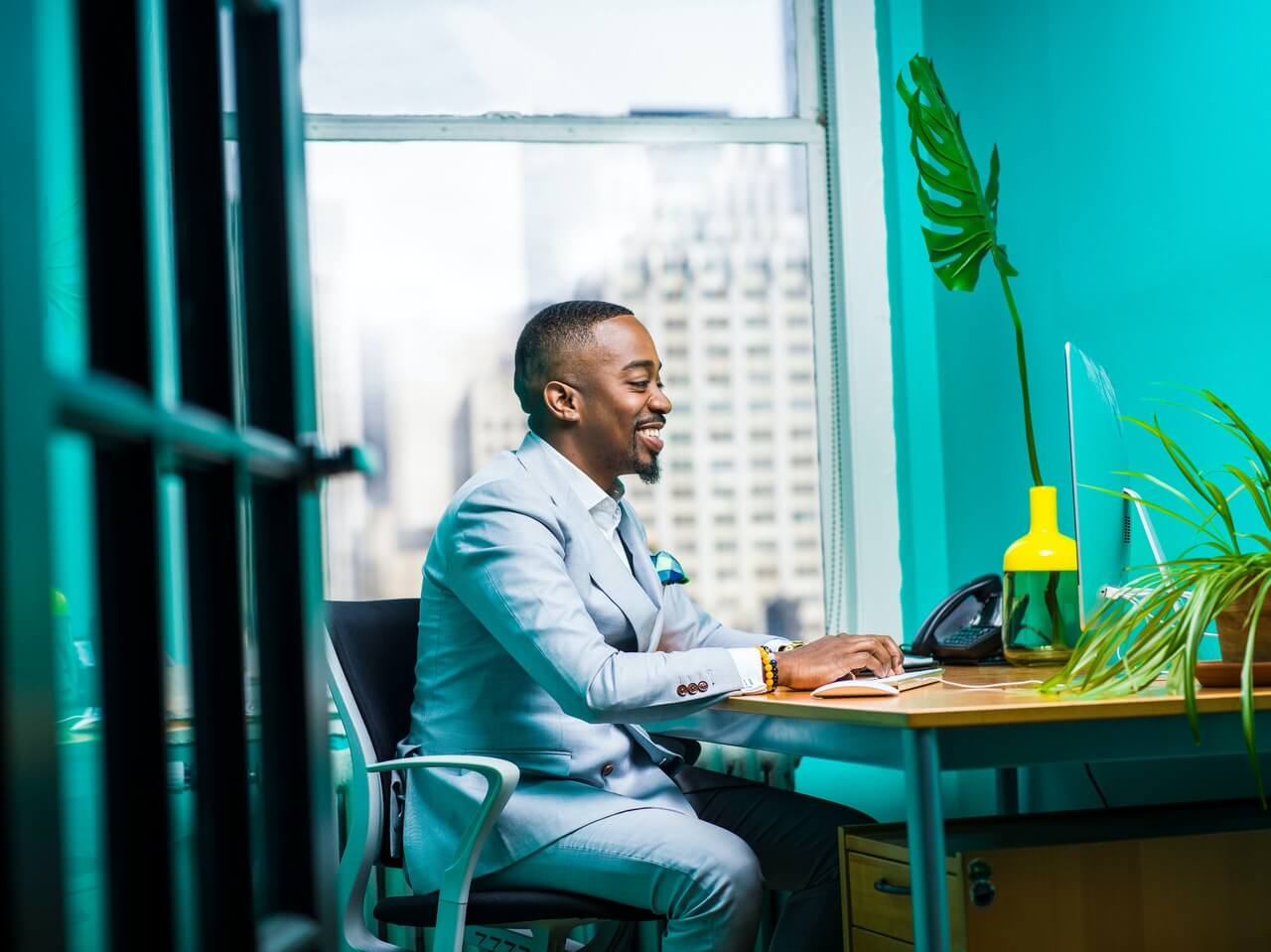 A smiling businessman sitting at his office