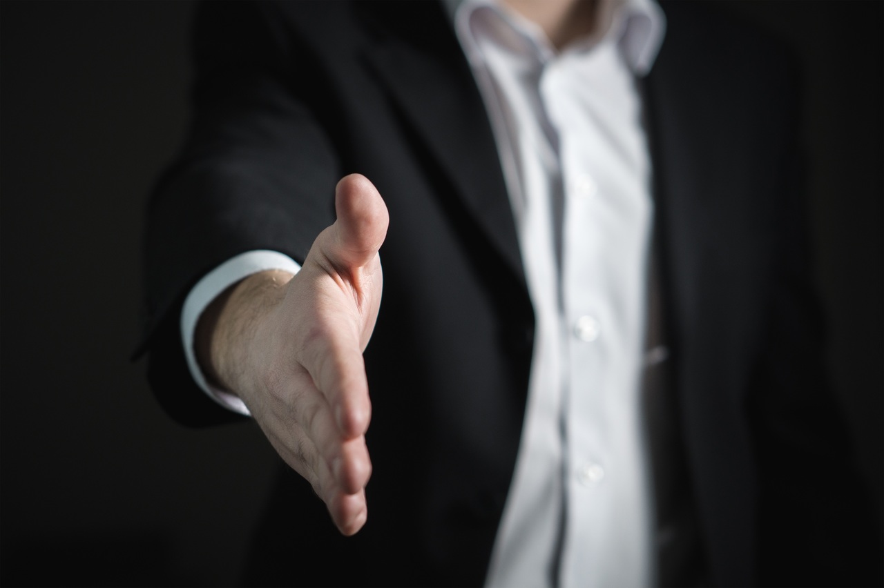 Man in suit stretching out his hand for a handshake