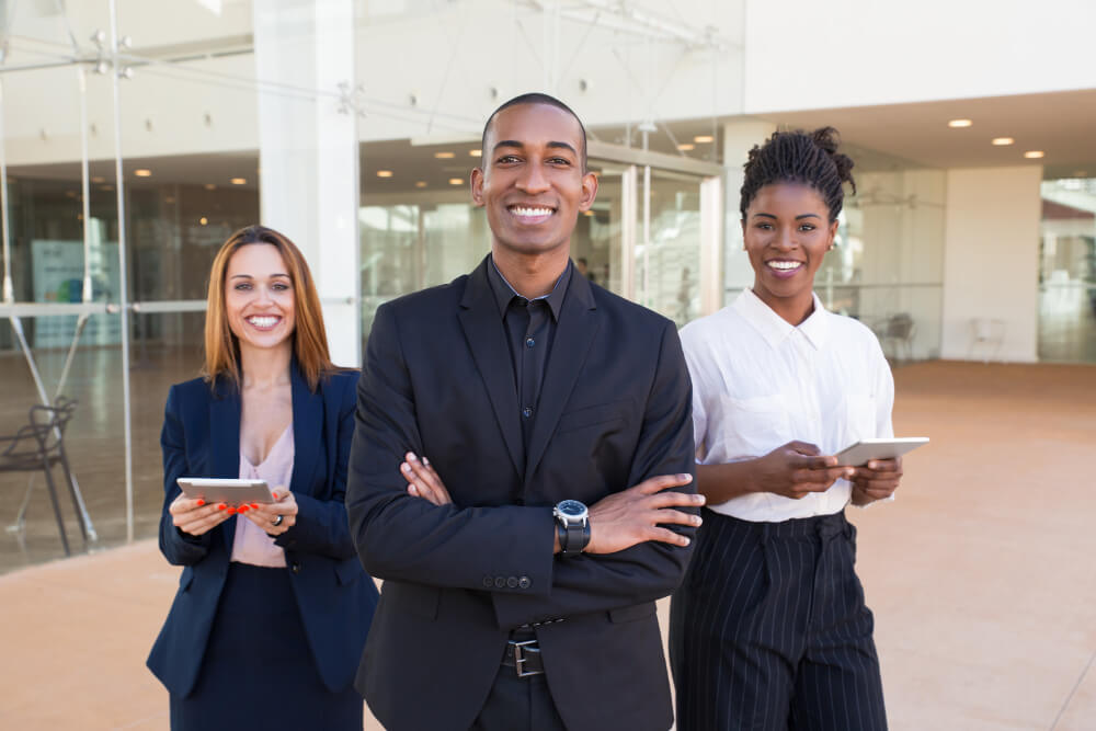 Group of businesspeople standing in front of an office building