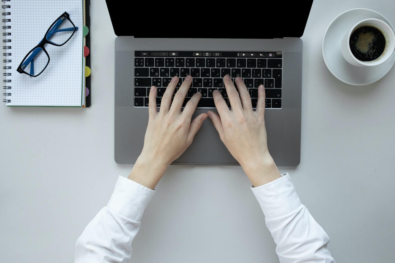 A person working on a business proposal with their laptop