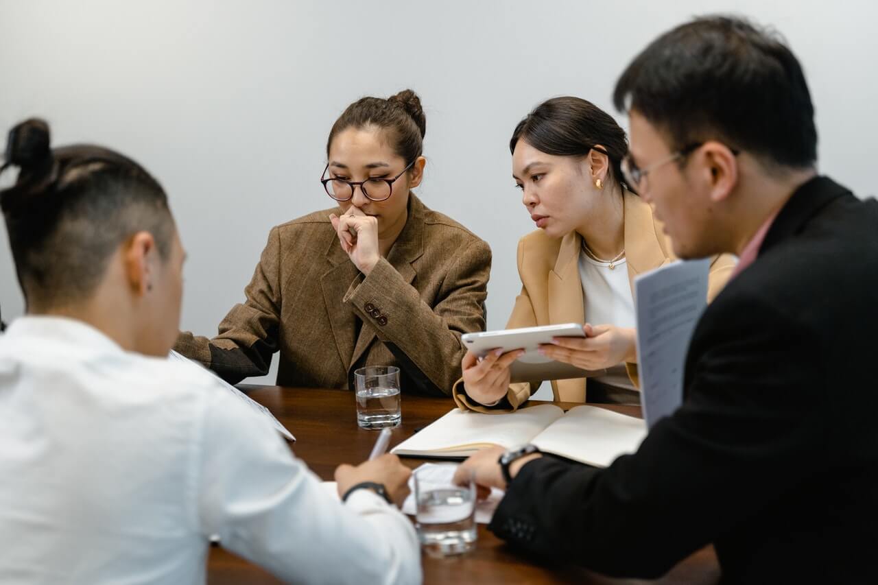 colleagues-working-together-in-an-office