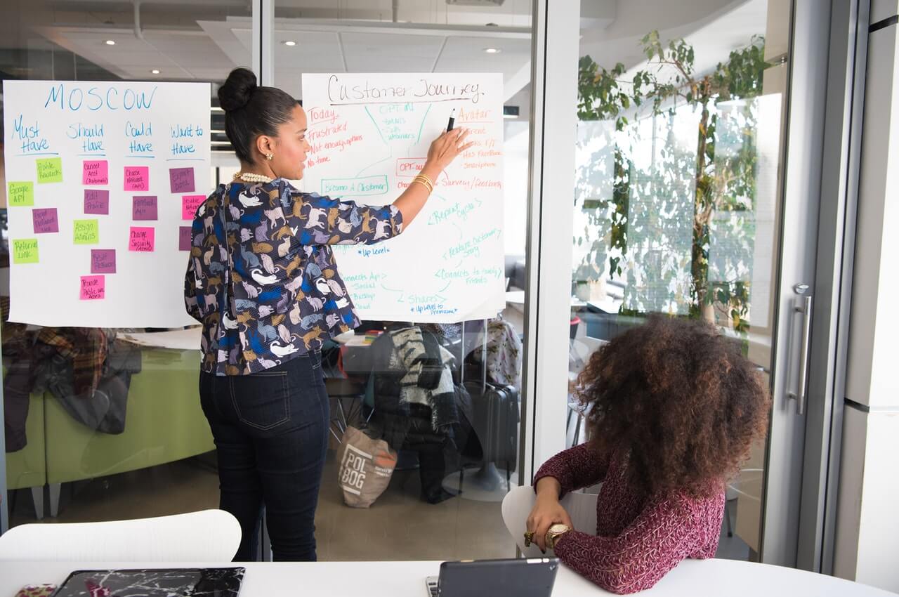 A-female-trainer-with-her-student-in-a-glass-framed-office