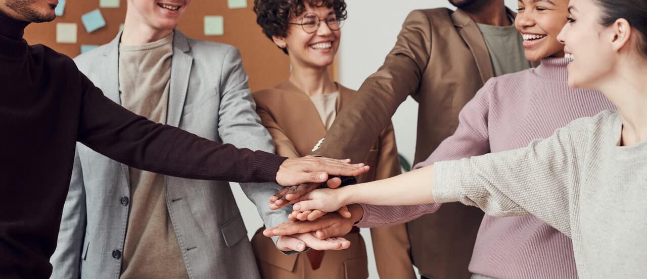 A-group-of-motivated-employees-holding-hands