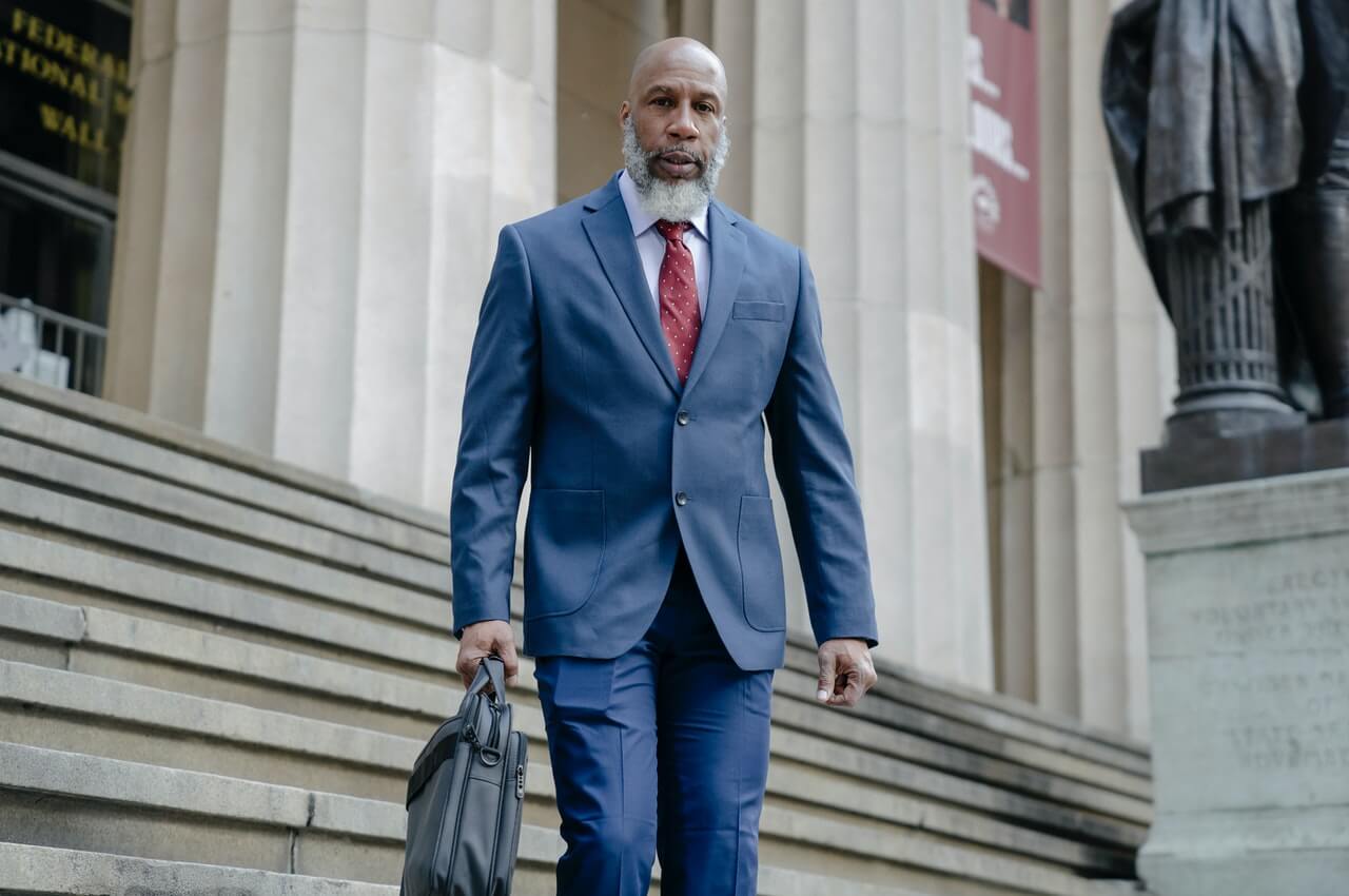 A-man-dressed-in-a-blue-suit-with-a-suitcase