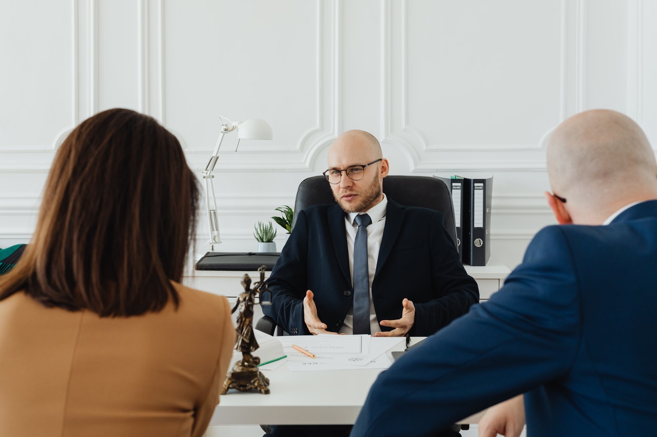 A-man-in-a-meeting-with-a-woman-and-another-man-in-his-office