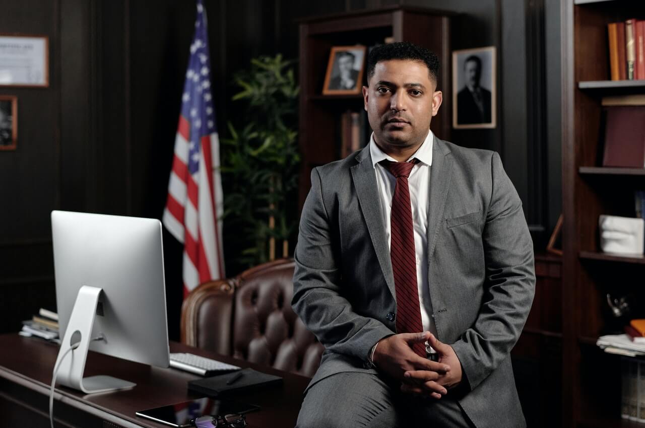 A-politician-sitting-on-his-desk-in-his-office.