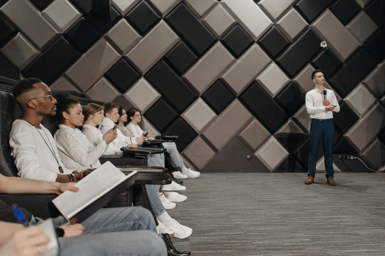 A-presenter-with-his-audience-looking-at-the-board