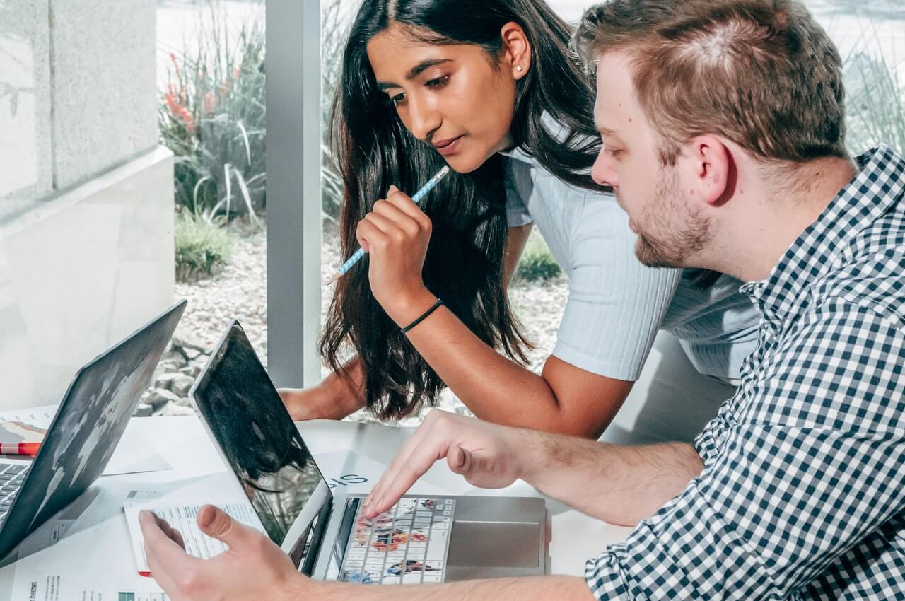 A-supervisor-checking-an-employees-work-on-her-laptop