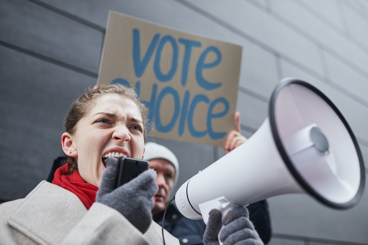 A-woman-using-a-public-address-microphone-to-talk-to-a-public