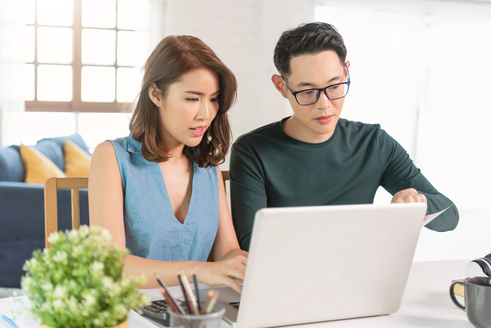 Work colleague teaching a colleague how to open a business account with ein only