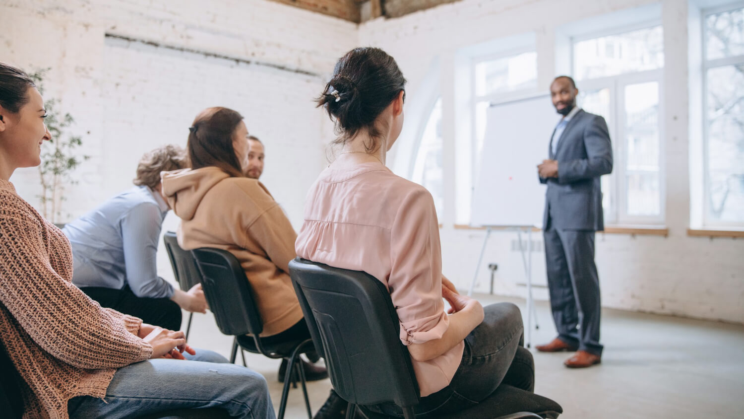 Male-speaker-giving-a-presentation-in-a-training-workshop