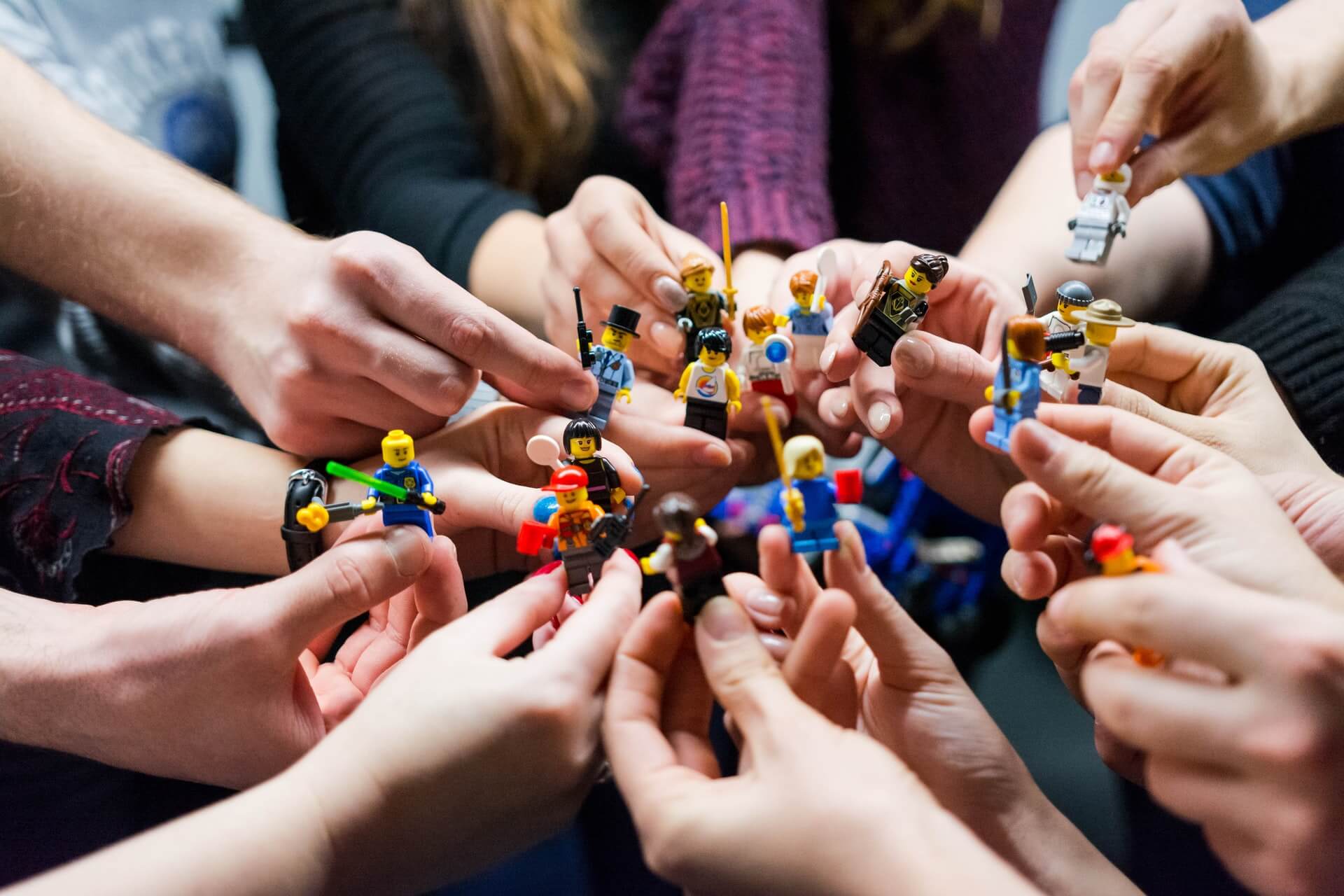 People-holding-miniature-objects