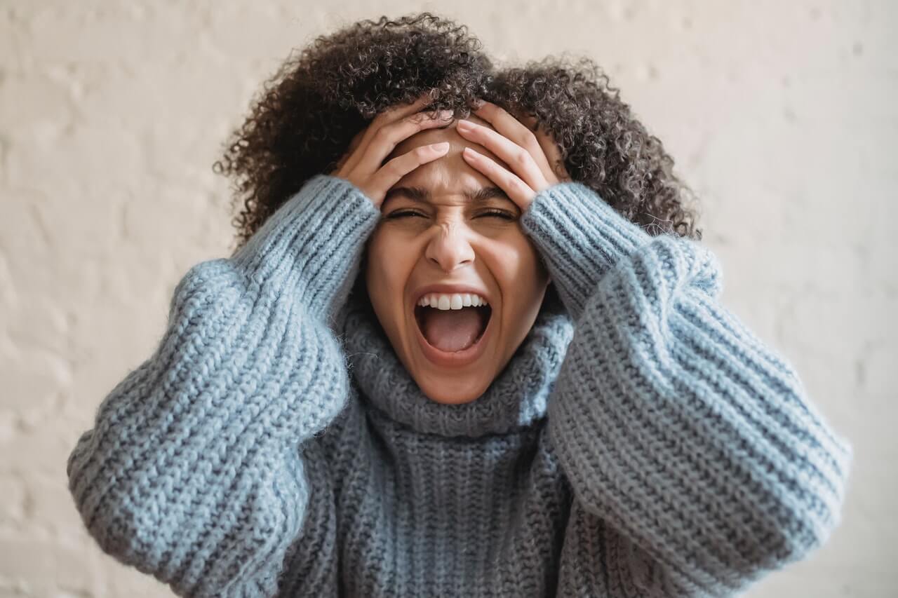 Upset employee screaming in an office room