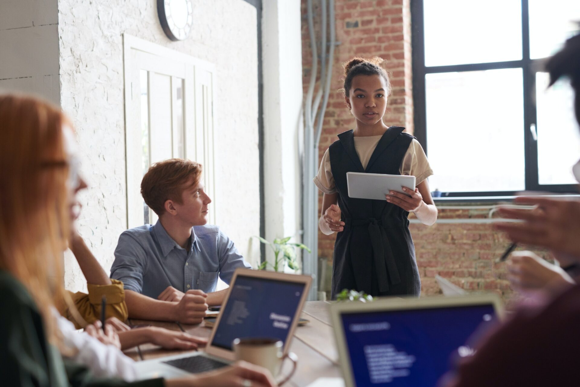 a young business lady presenting to a group of people