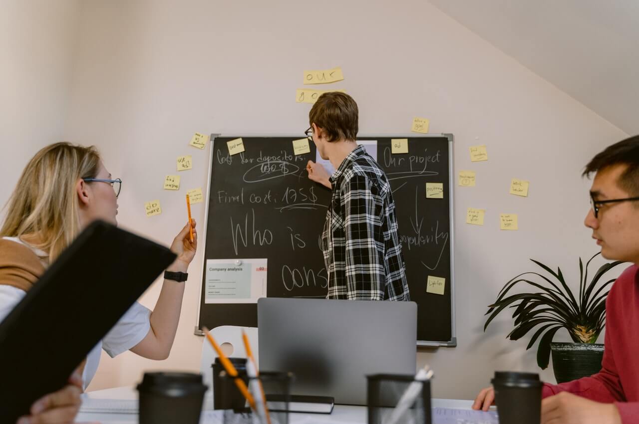 employees-in-an-aorganization-looking-at-a-trainer-writing-in-a-board