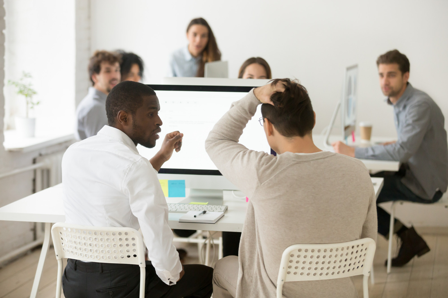 stressed business man telling his team of not so good news