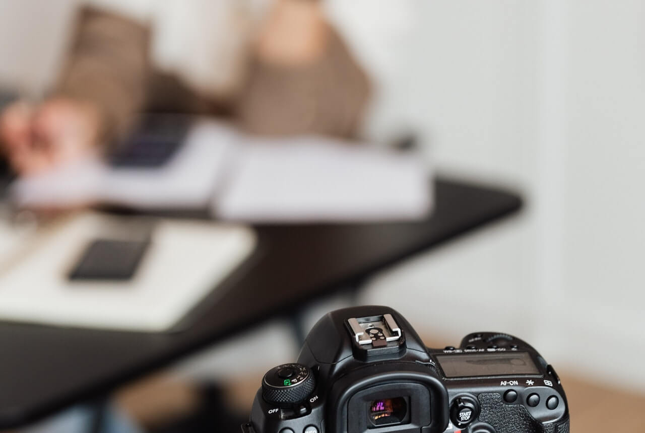 A-blur-image-of-an-office-woman-and-a-camera