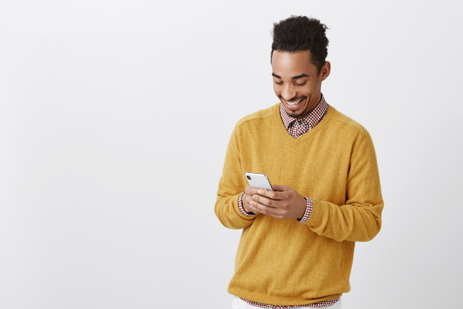 A-boy-laughing-while-watching-a-snapchat-video-with-his-phone