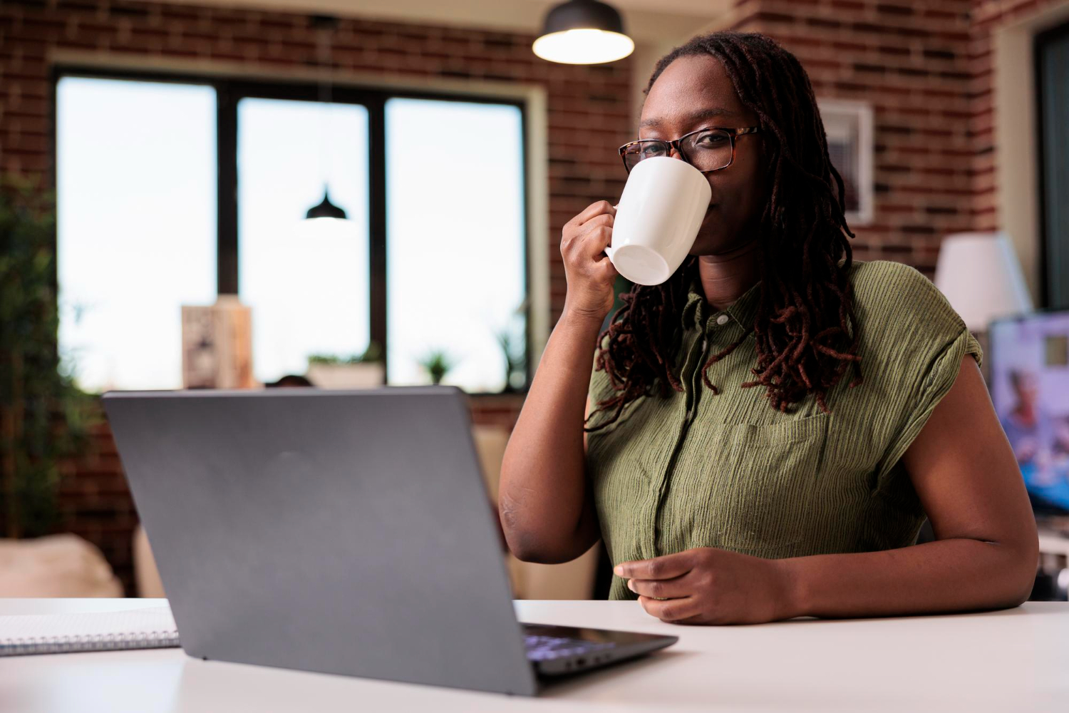 A-female-freelancer-taking-a-coffee-break-during-work-hours.