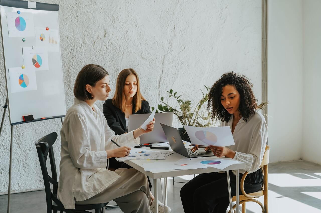 Business women working together on a chart