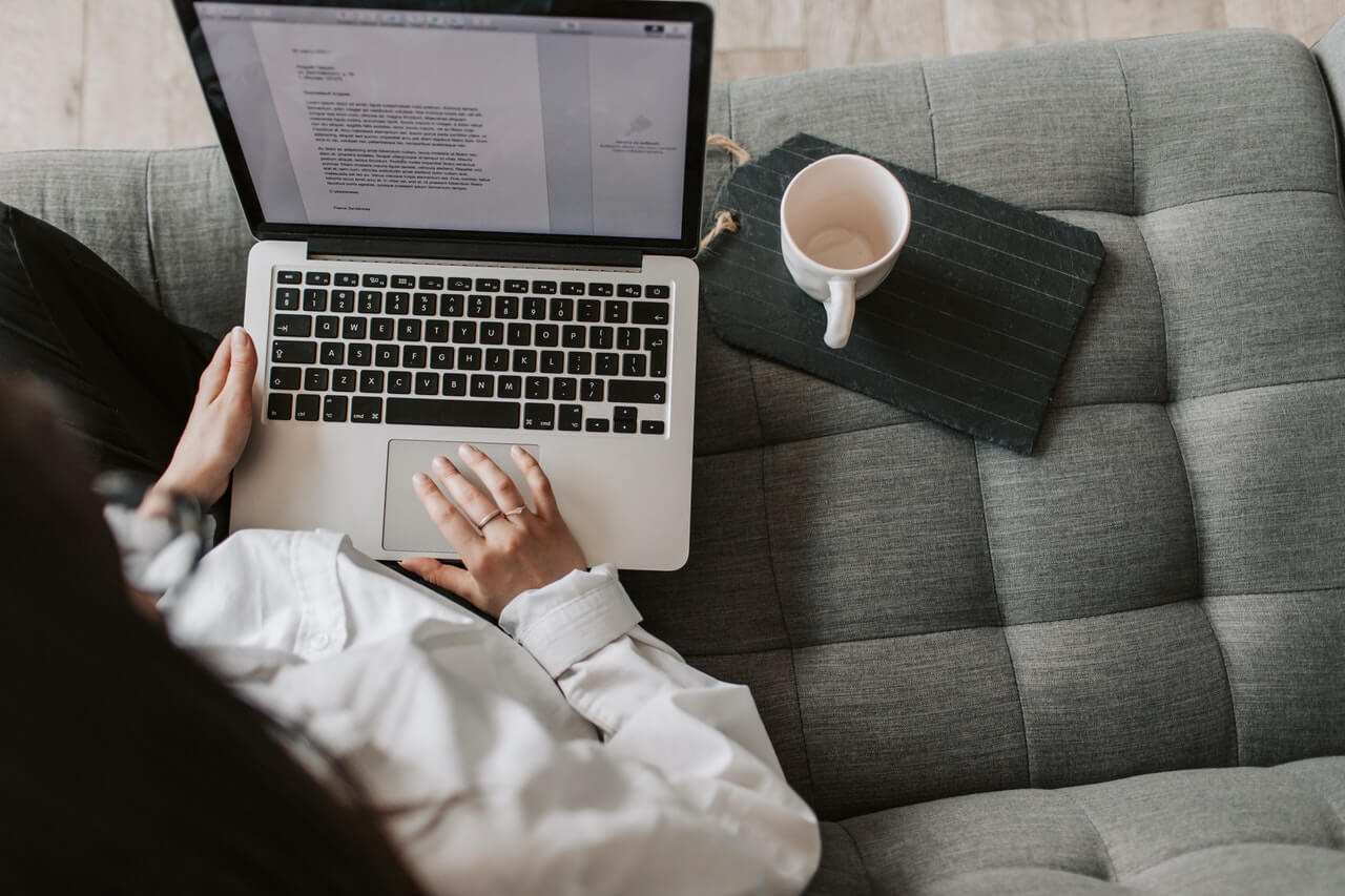 A-journalist-typing-a-story-with-her-laptop