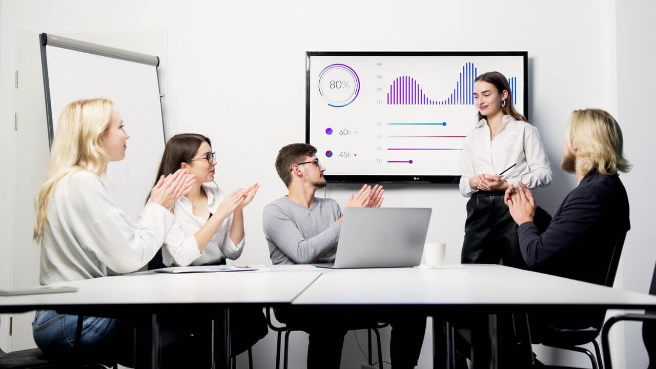 A businesswoman presenting at a meeting with slides