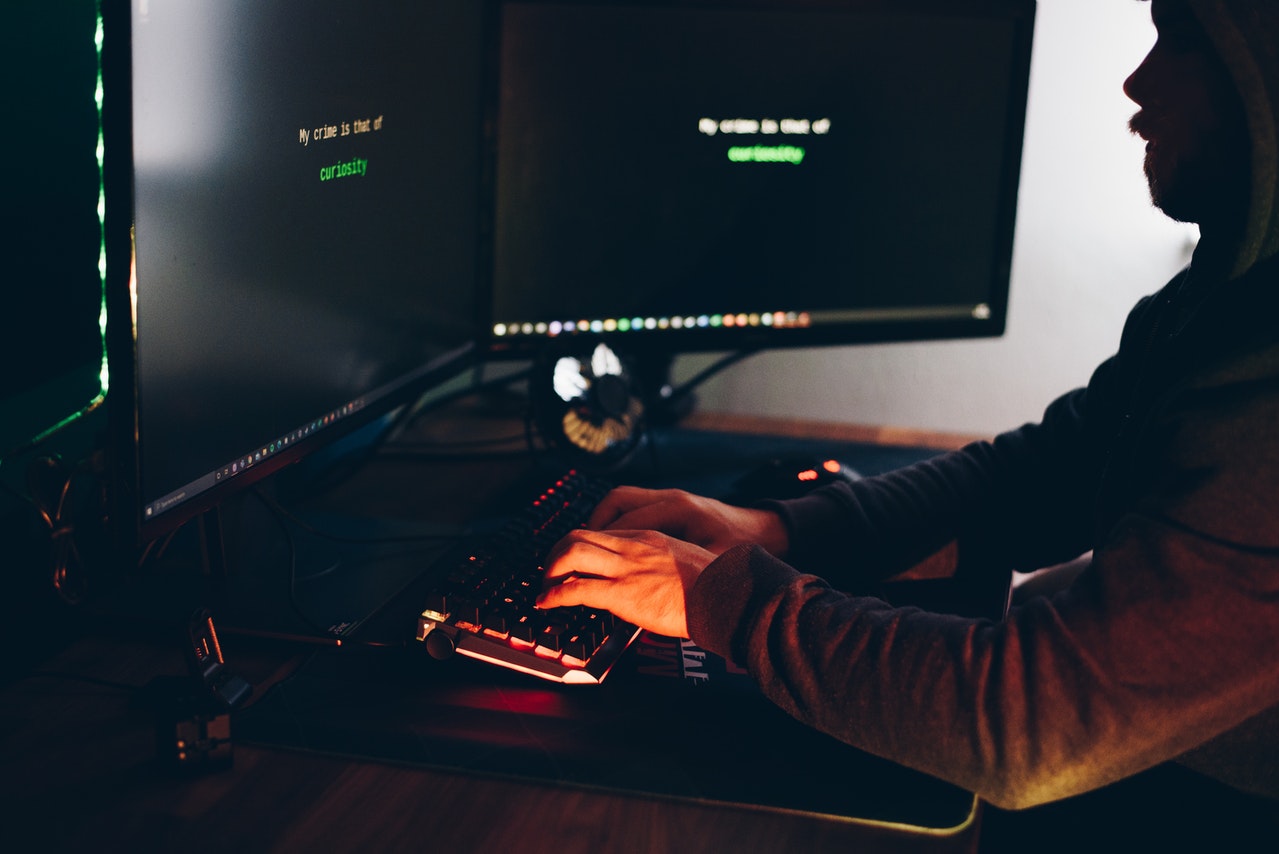 A-male-hacker-typing-with-his-keyboard-and-watching-the-system