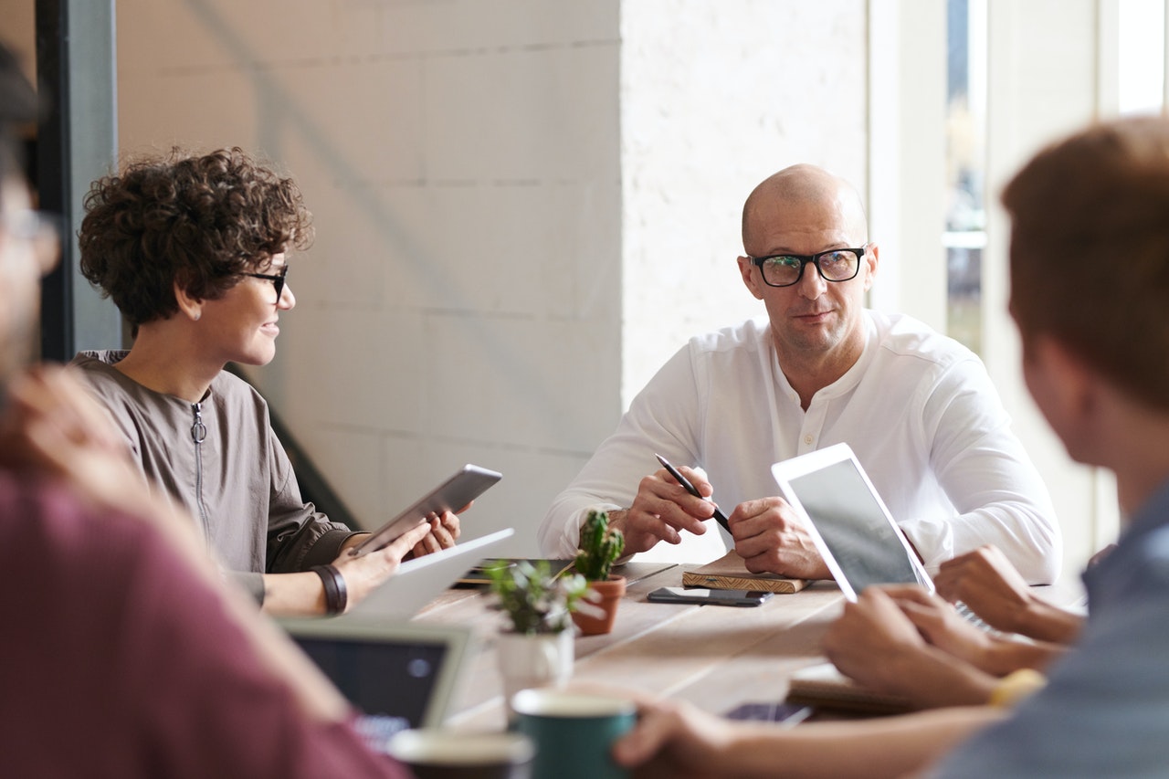 A-man-sitting-infront-of-colleagues-during-a-meeting-session