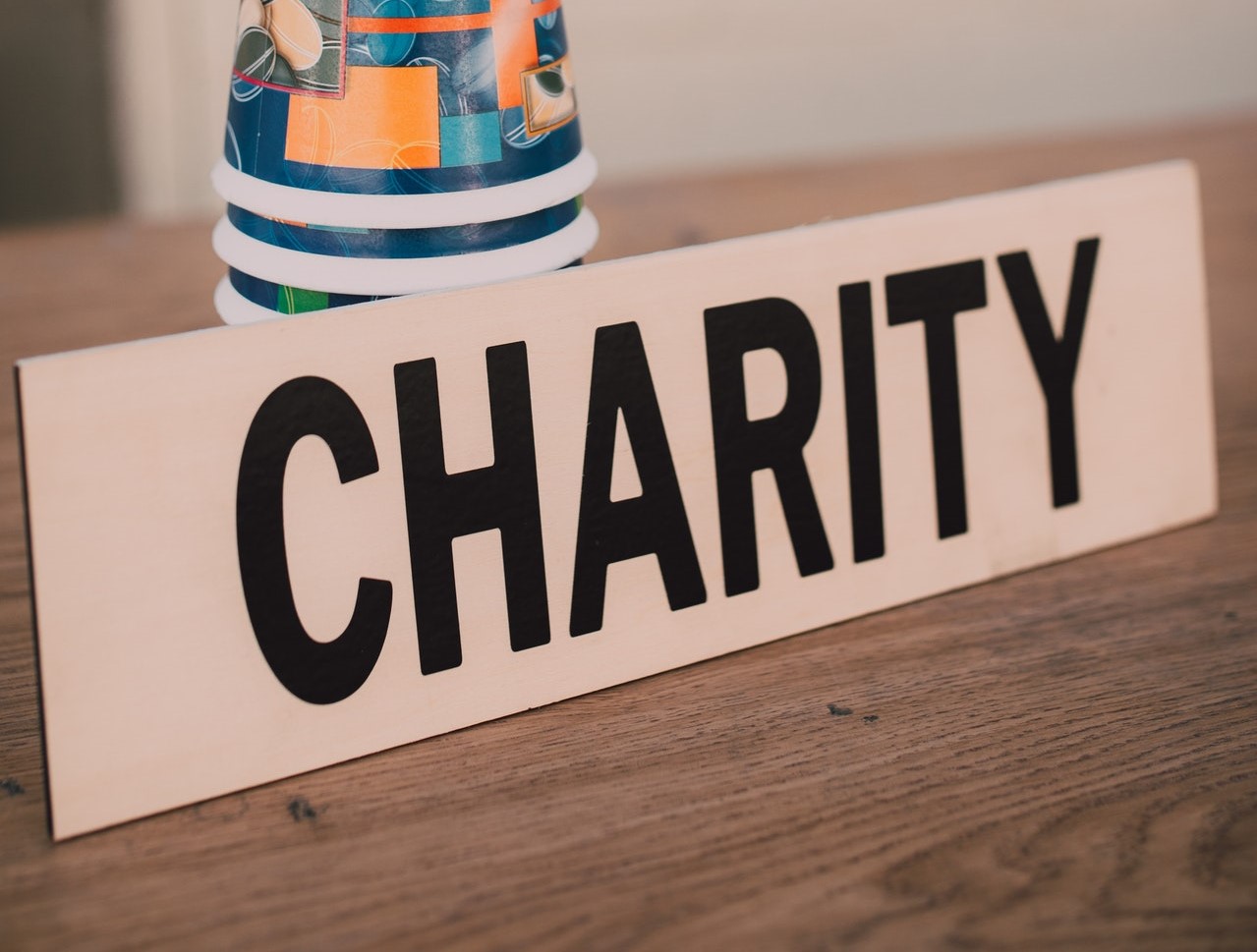 Charity written on a wooden piece